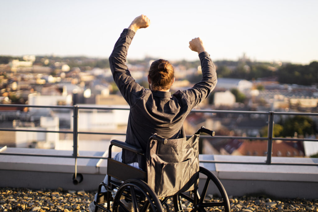 Participant in wheel chair raising arms