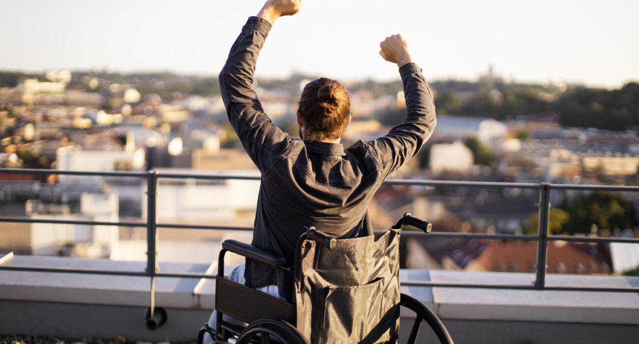 Participant in wheel chair raising arms